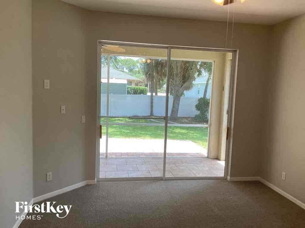 A room with a sliding glass door leading to a backyard.
