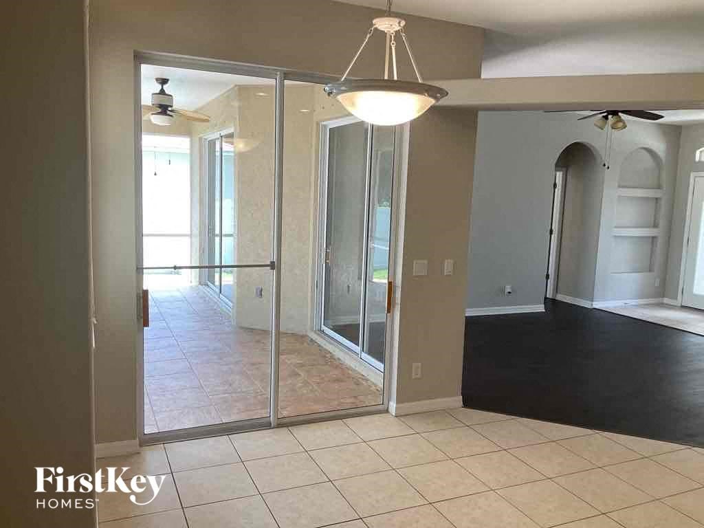 A room with a sliding glass door leading to a balcony.