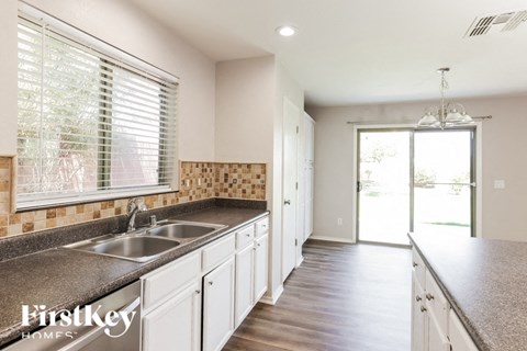 A kitchen with a sink and a window.