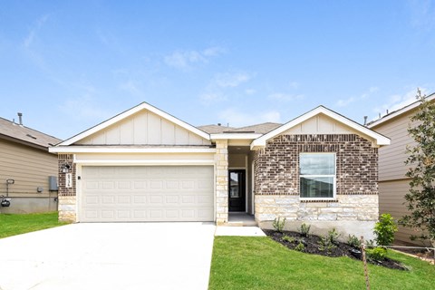 a house with a garage door and a lawn