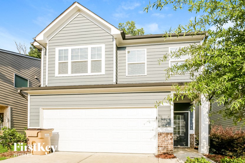a white garage door in front of a house