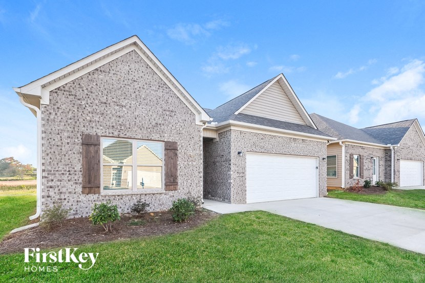 a brick house with a white garage door