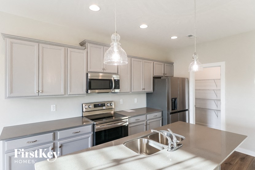 a kitchen with stainless steel appliances and white cabinets
