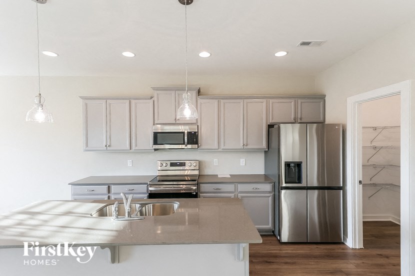 a kitchen with stainless steel appliances and white cabinets
