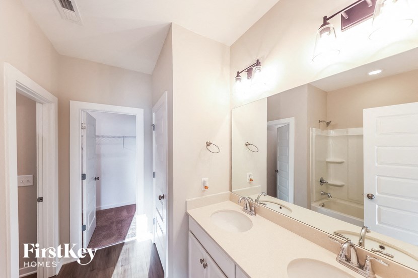 a bathroom with two sinks and a large mirror