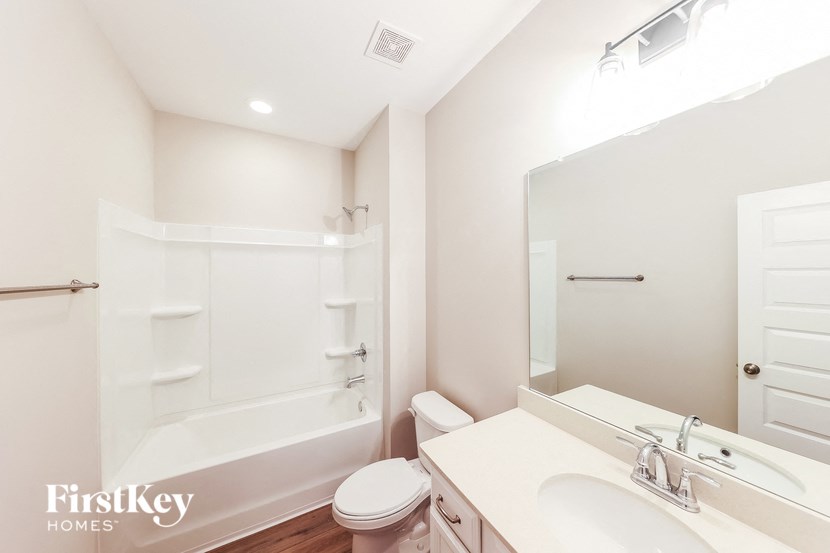 a bathroom with a sink toilet and a bath tub