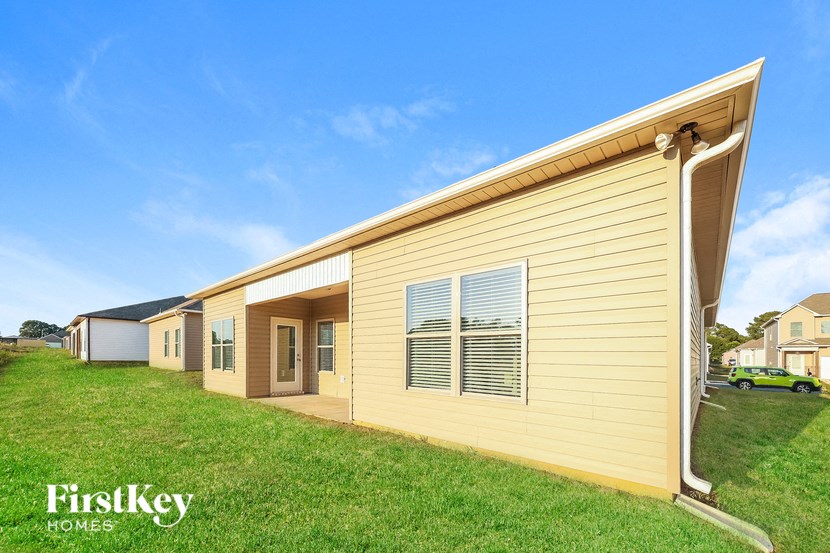 a yellow house with a grassy yard in front of it