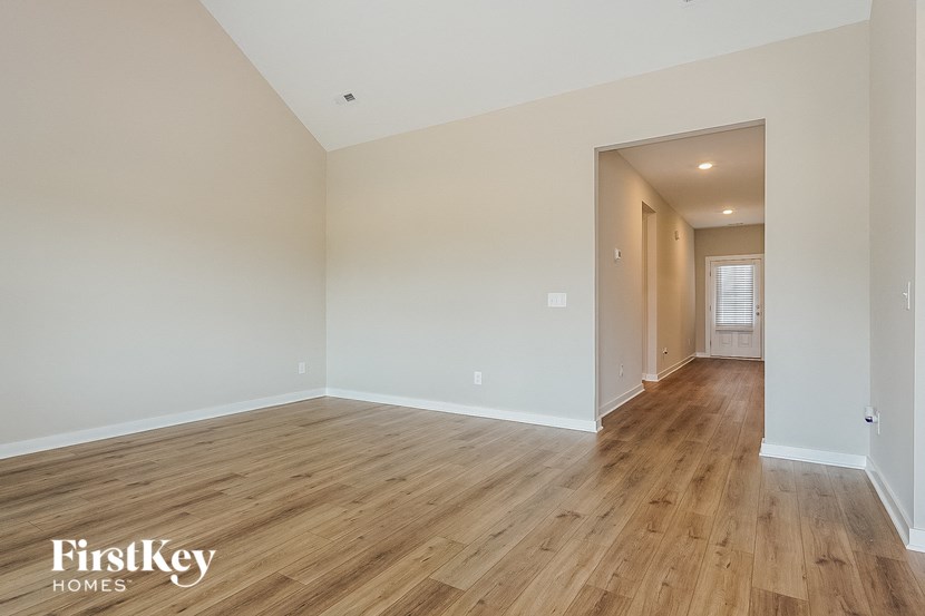 the spacious living room and dining room with hardwood flooring