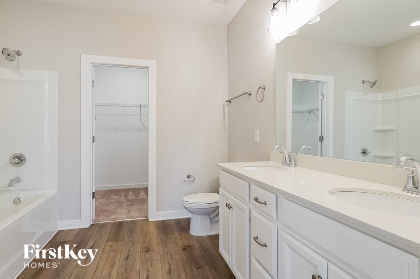 a bathroom with a toilet and a sink and a shower
