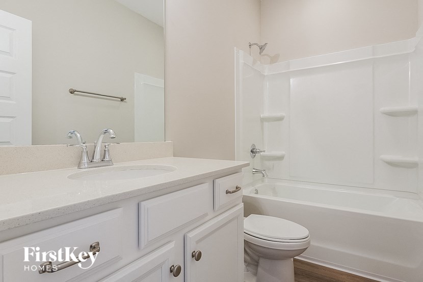 a bathroom with a sink toilet and a bath tub