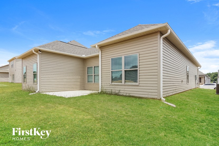 a small house with a grassy yard in front of it