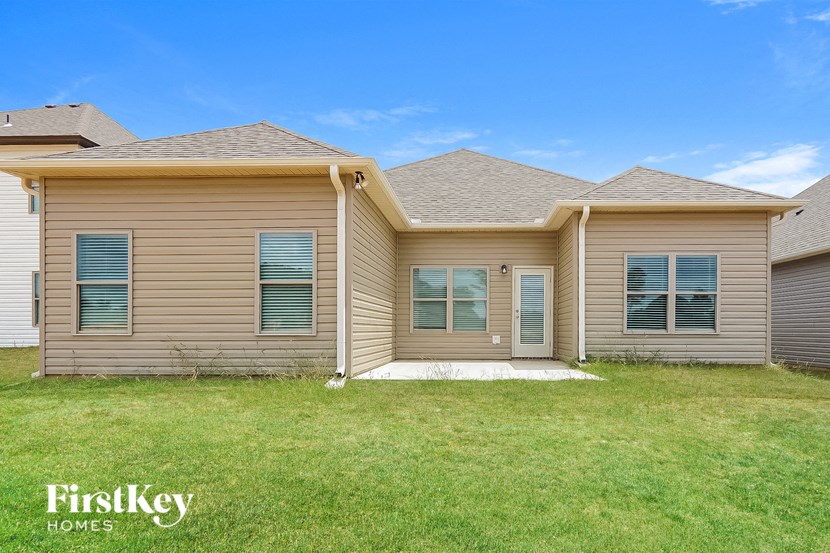 a brand new house with a grassy yard and a roof