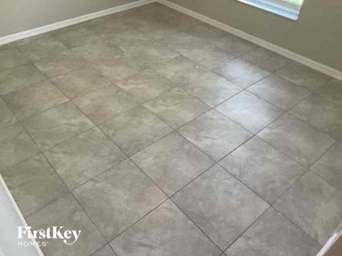 A room with a tile floor and a window.