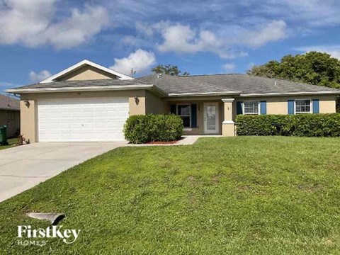 A house with a garage door is for sale by FirstKey Homes.