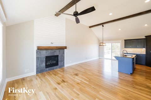 a living room with a fireplace and a hard wood floor