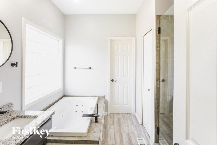 A bathroom with a tub and a sink.