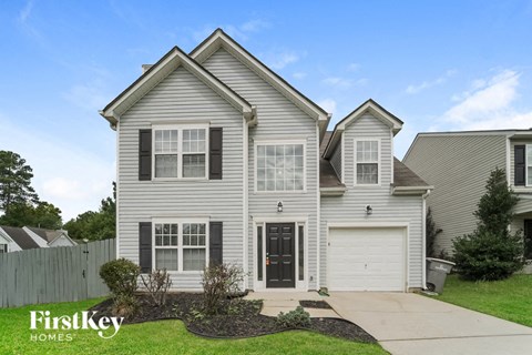 A two-story house with a garage is for sale.