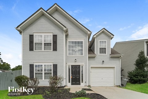 A two-story house with a garage is for sale by FirstKey Homes.