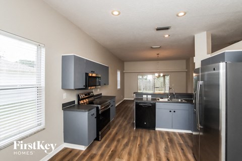a kitchen with stainless steel appliances and a large window