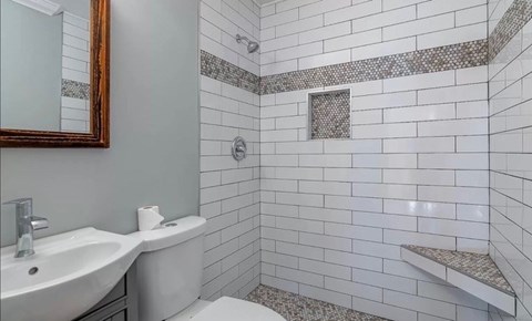 a white bathroom with a sink and a toilet