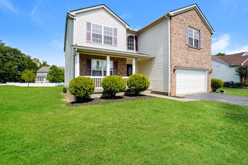 A house with a well-maintained lawn in front.