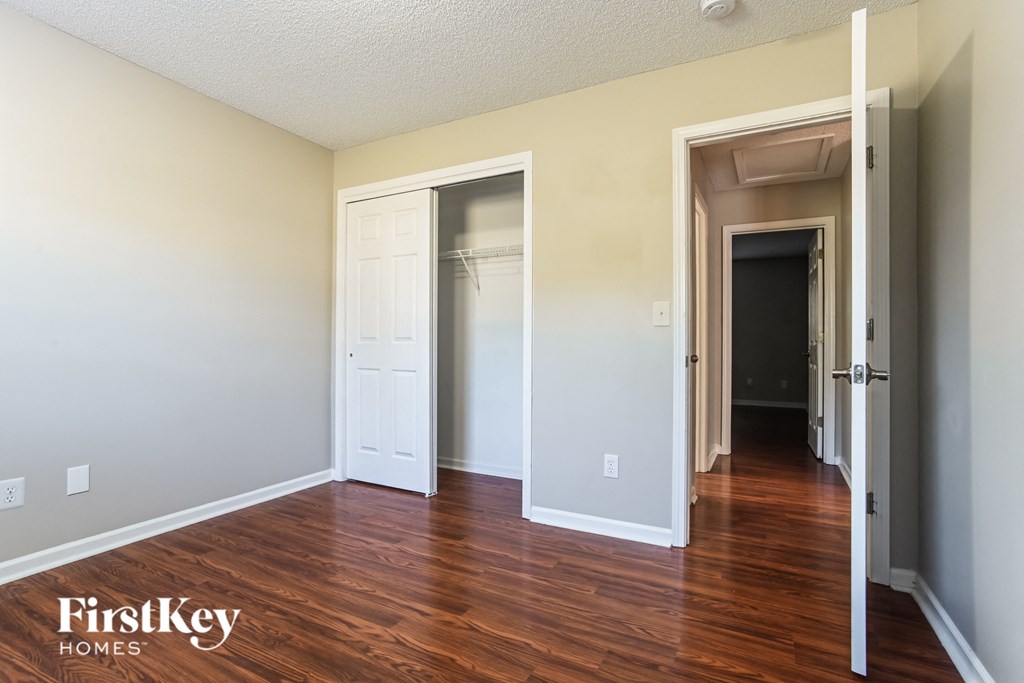 a living room with a hard wood floor and a closet
