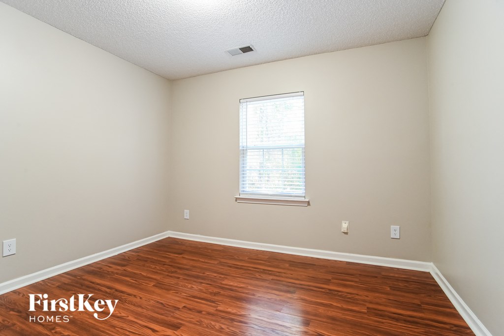 a room with a hard wood floor and a window
