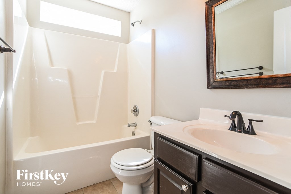 a bathroom with a sink toilet and a bath tub