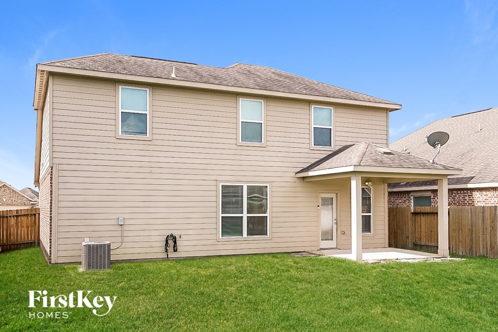 A house with a brown roof and a covered patio.