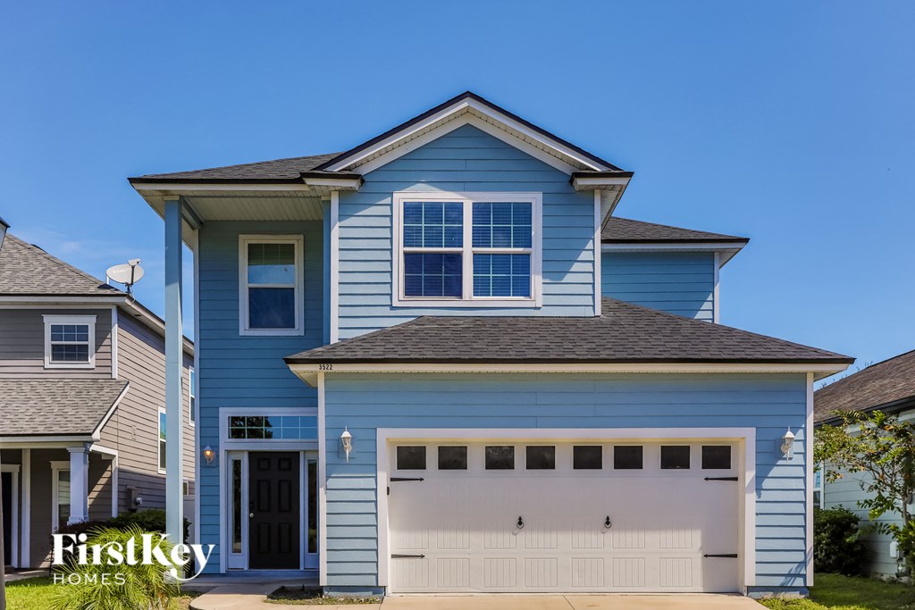 a blue house with a white garage door