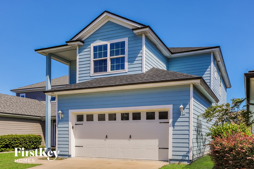 a blue house with a white garage door