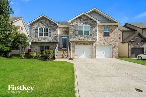 A house with a garage and a driveway is for sale.