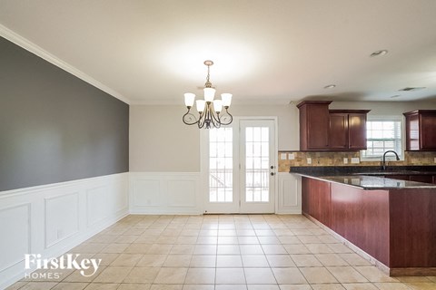 A kitchen with a chandelier and a sink.