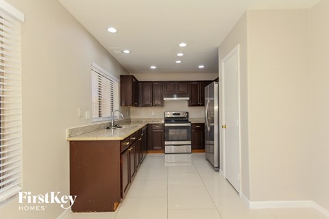 A kitchen with brown cabinets and a white countertop.