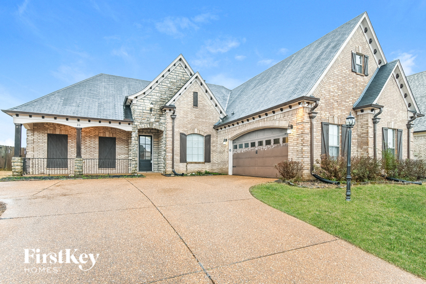 a large brick house with a driveway and a garage door