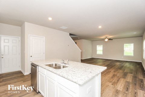 A kitchen with a sink and a counter top.