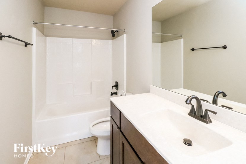 a bathroom with a sink and a shower and a toilet