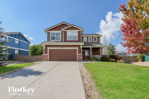 a large house with a driveway and a garage door