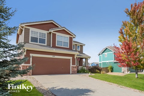 a home with a brown and green house and a garage door