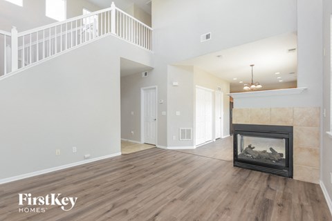 the living room of a new home with a fireplace