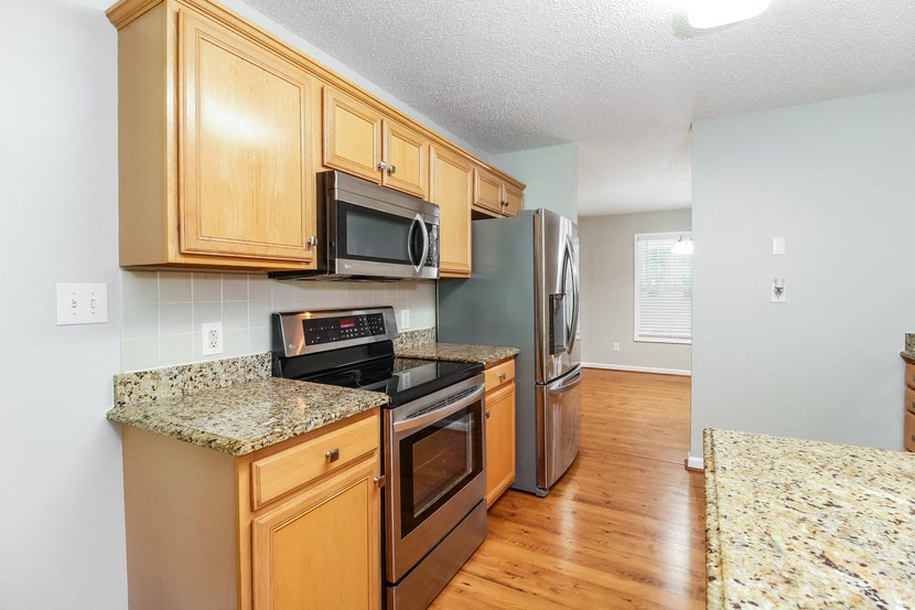 a kitchen with stainless steel appliances and wooden cabinets