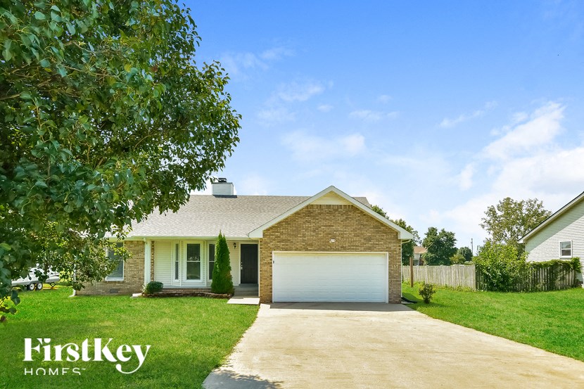 a small brick house with a white garage door