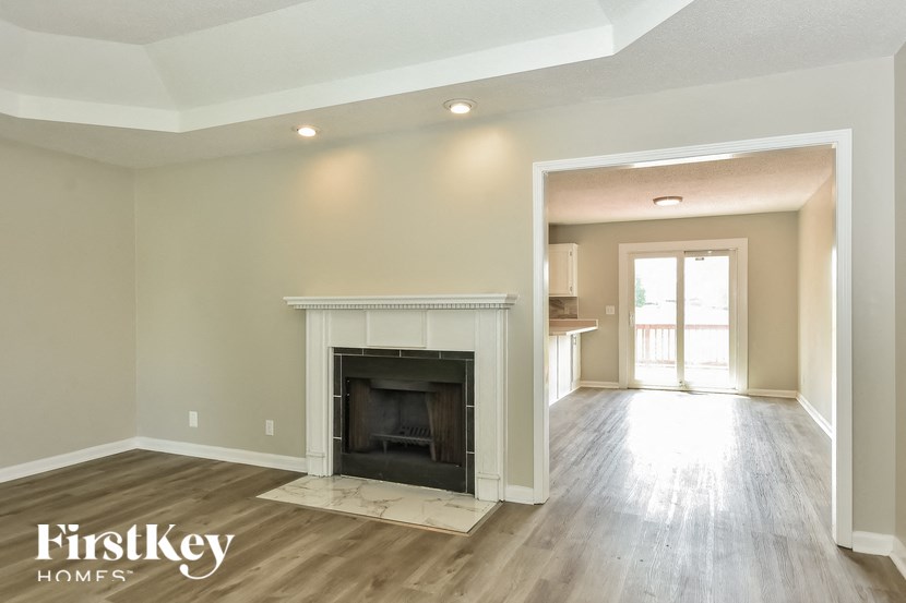 the living room and dining room with a fireplace