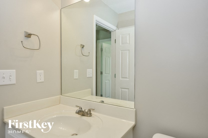 a bathroom with a sink and a large mirror
