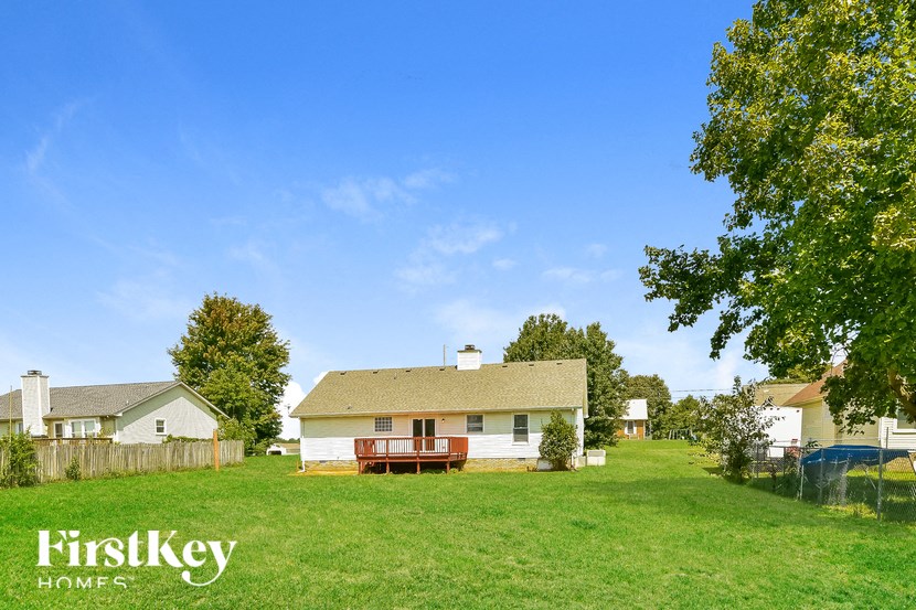 a house in the middle of a grassy yard