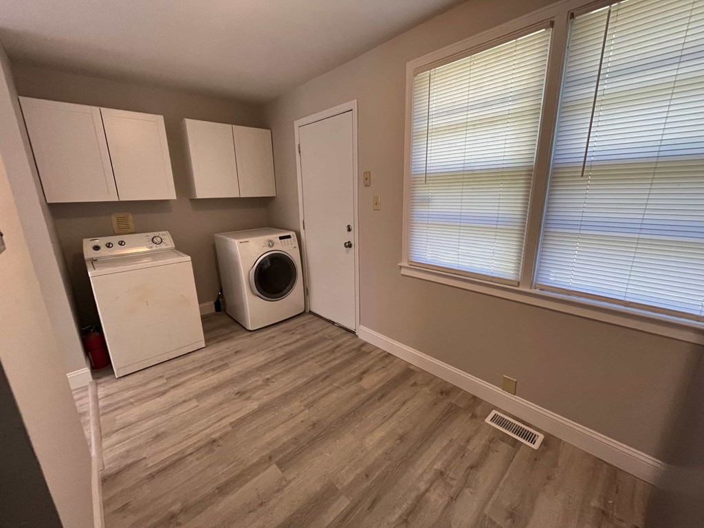 a laundry room with a washer and dryer and a window