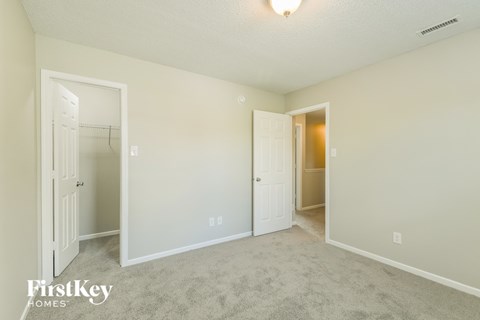 a bedroom with two closets and a door to a closet