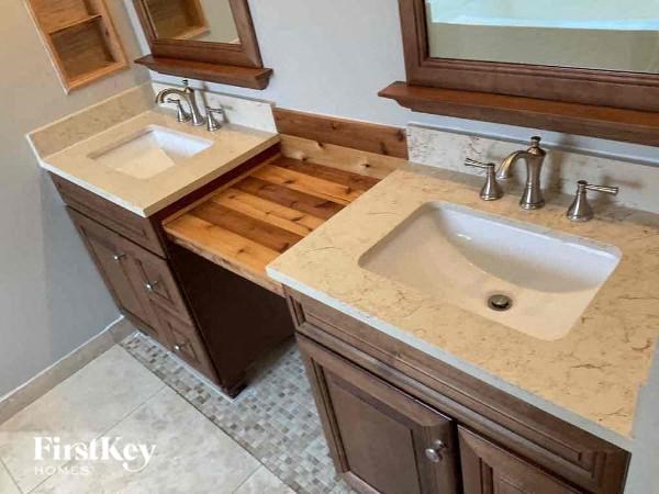 a bathroom with two sinks and a mirror