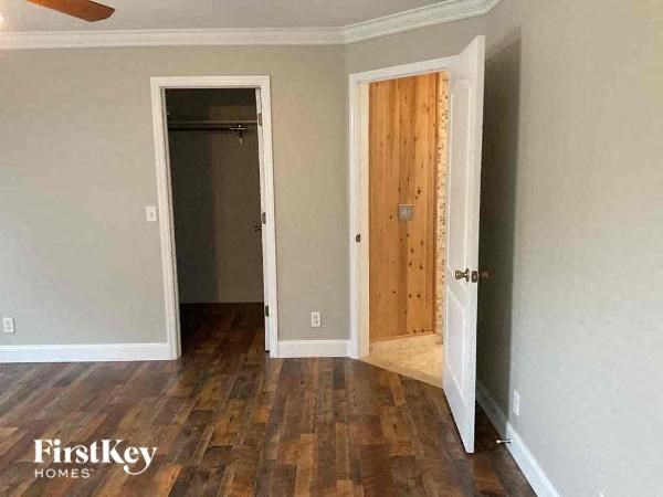 a empty room with a wooden floor and two doors