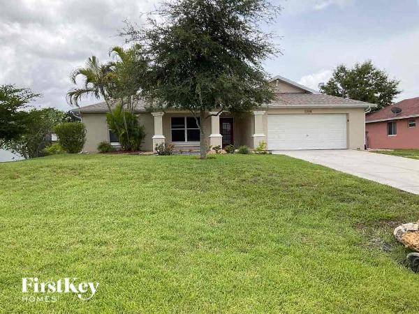 a white house with a lawn in front of it
